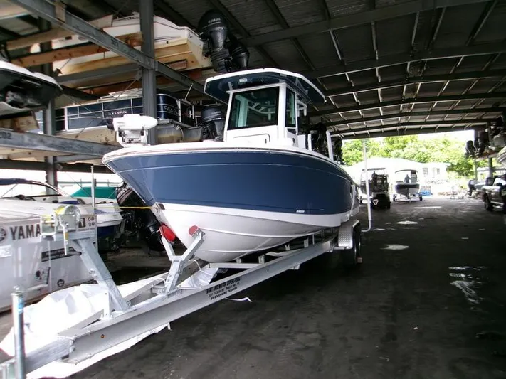 Yacht Photos Pics 2026 Blackfin 242 HB boat on trailer in covered storage area.