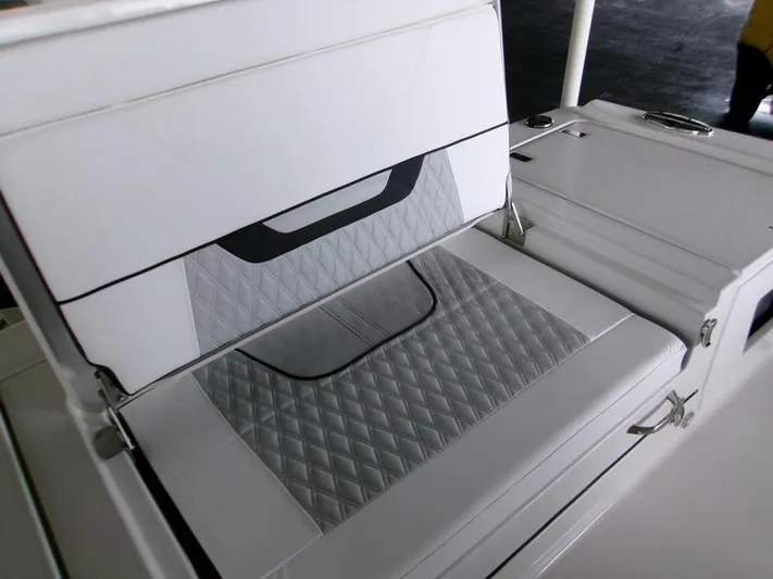  Yacht Photos Pics 2026 Blackfin 242 HB boat seat with diamond-patterned upholstery and storage compartment.