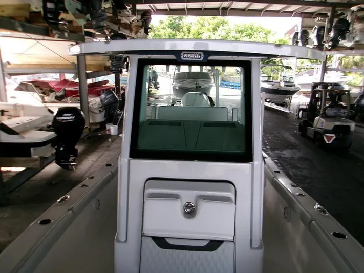  Yacht Photos Pics 2026 Blackfin 242 HB boat in storage, surrounded by other vessels and equipment.