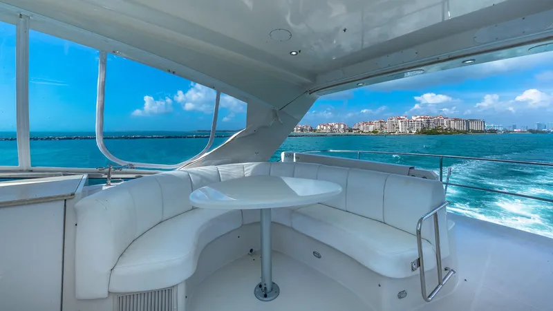 Next To Sell Yacht Photos Pics Luxurious 2005 Marquis 59 yacht interior with ocean view and white seating area.