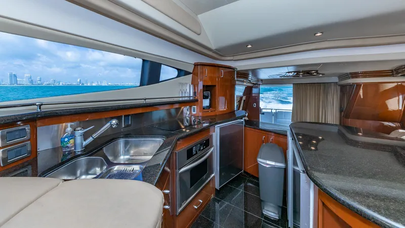 Next To Sell Yacht Photos Pics Luxurious 2005 Marquis 59 yacht interior with modern kitchen and ocean view.