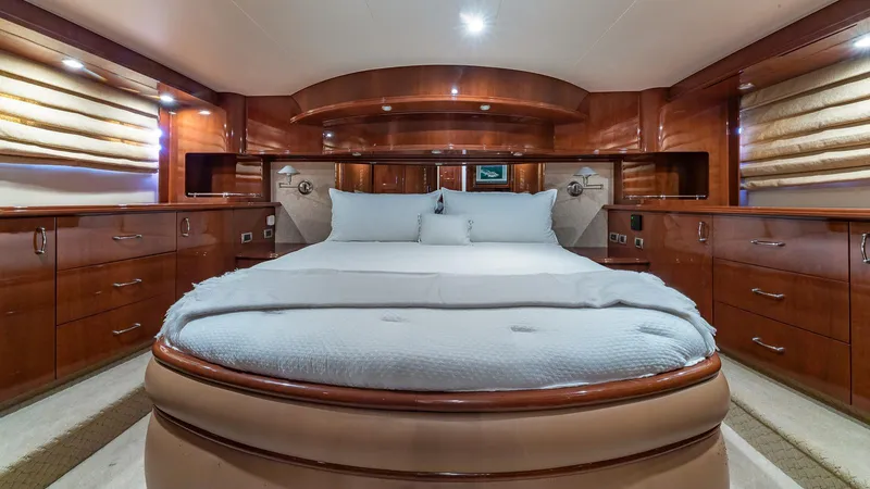 Next To Sell Yacht Photos Pics Luxurious 2005 Marquis 59 yacht bedroom with elegant wood finishes and plush bedding.