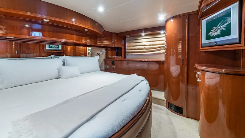 Next To Sell Yacht Photos Pics Luxurious 2005 Marquis 59 yacht bedroom with elegant wood paneling and modern amenities.
