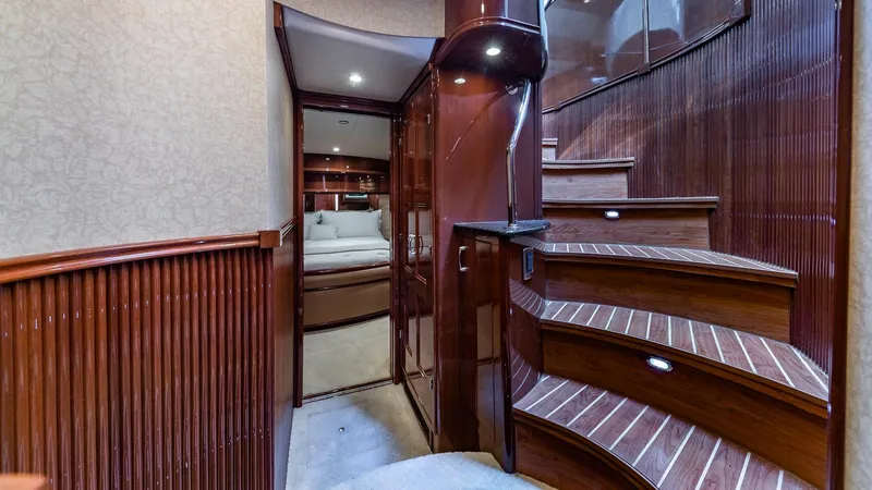 Next To Sell Yacht Photos Pics Luxurious interior of 2005 Marquis 59 yacht with elegant wooden staircase and cozy cabin.