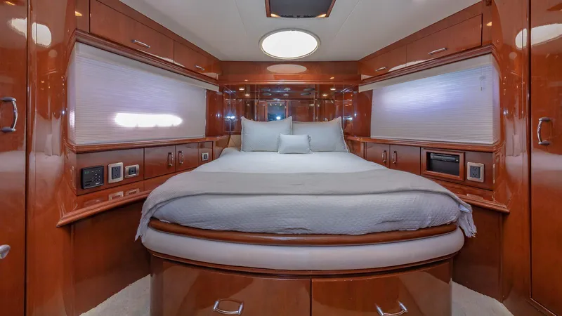Next To Sell Yacht Photos Pics Luxurious 2005 Marquis 59 yacht bedroom with elegant wood finish and cozy bedding.