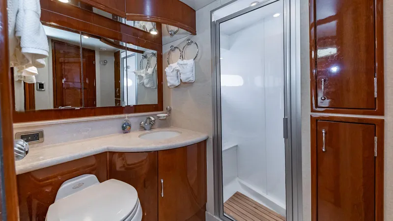 Next To Sell Yacht Photos Pics Luxurious bathroom in 2005 Marquis 59 yacht with wood cabinetry and modern shower.