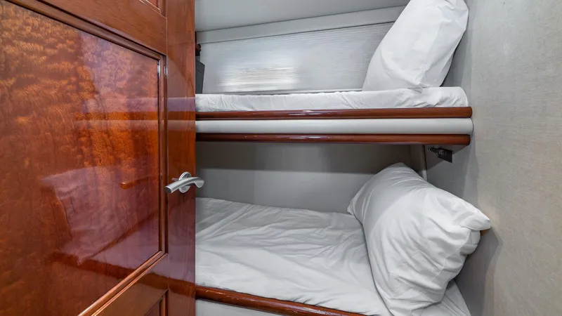 Next To Sell Yacht Photos Pics Bunk beds in 2005 Marquis 59 yacht cabin with wooden door.