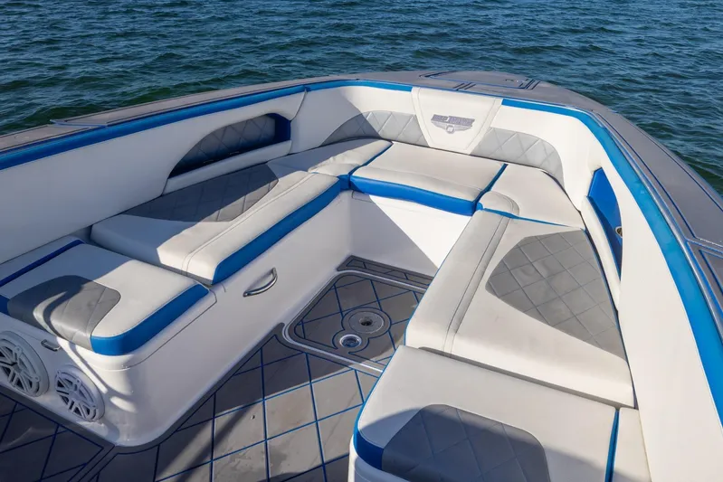 Loan Shark II Yacht Photos Pics 2019 Deep Impact 399 Sport boat interior with blue and white cushioned seating.