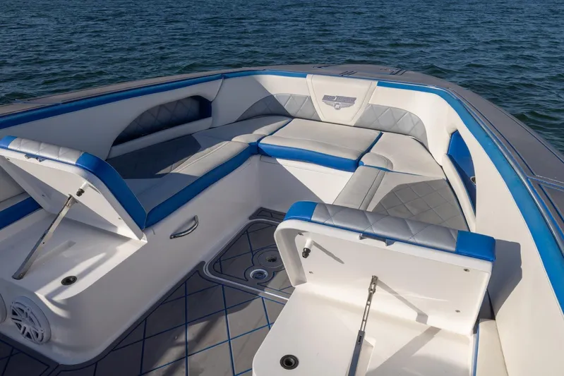 Loan Shark II Yacht Photos Pics 2019 Deep Impact 399 Sport boat interior with blue and gray seating on water.