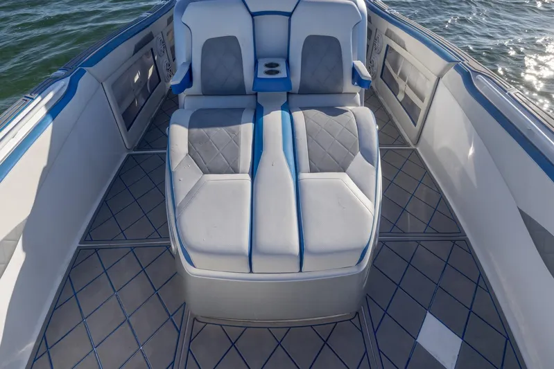 Loan Shark II Yacht Photos Pics 2019 Deep Impact 399 Sport boat interior with cushioned seating and blue accents.