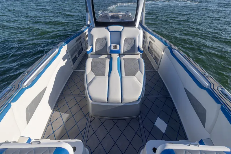 Loan Shark II Yacht Photos Pics 2019 Deep Impact 399 Sport boat interior with blue and gray seating on water.