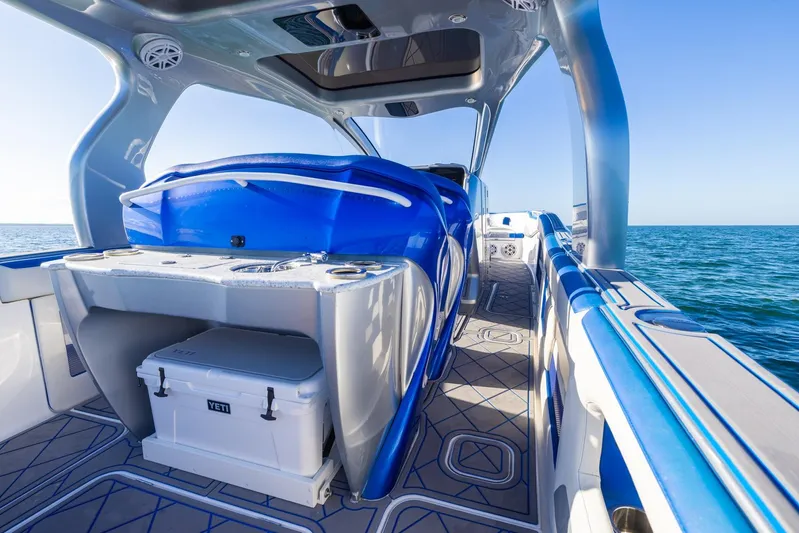 Loan Shark II Yacht Photos Pics 2019 Deep Impact 399 Sport boat interior with blue seating and ocean view.