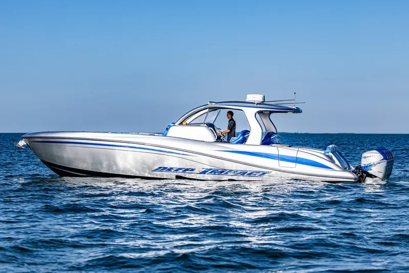 Loan Shark II Yacht Photos Pics 2019 Deep Impact 399 Sport boat cruising on open water under clear blue sky.