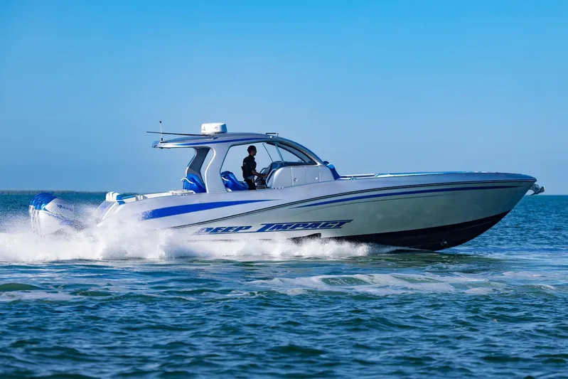 Loan Shark II Yacht Photos Pics 2019 Deep Impact 399 Sport boat cruising on open water under clear blue skies.