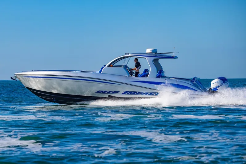 Loan Shark II Yacht Photos Pics 2019 Deep Impact 399 Sport boat cruising on open water under clear blue sky.