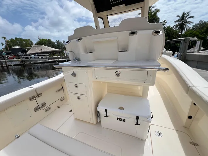  Yacht Photos Pics 2026 Scout 260 LXF boat interior with storage and Yeti cooler on deck.