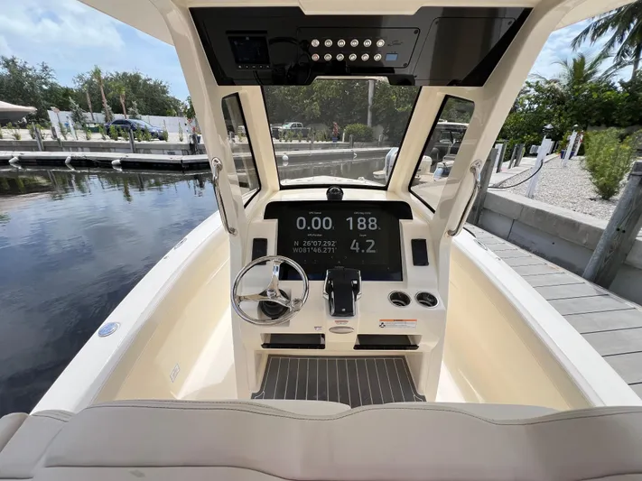  Yacht Photos Pics 2026 Scout 260 LXF boat dashboard with steering wheel and digital display.