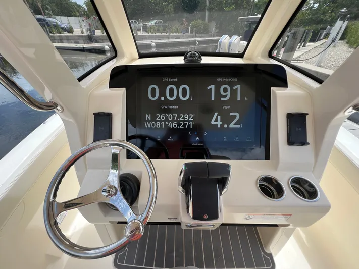 Yacht Photos Pics 2026 Scout 260 LXF boat dashboard with GPS display and steering wheel.