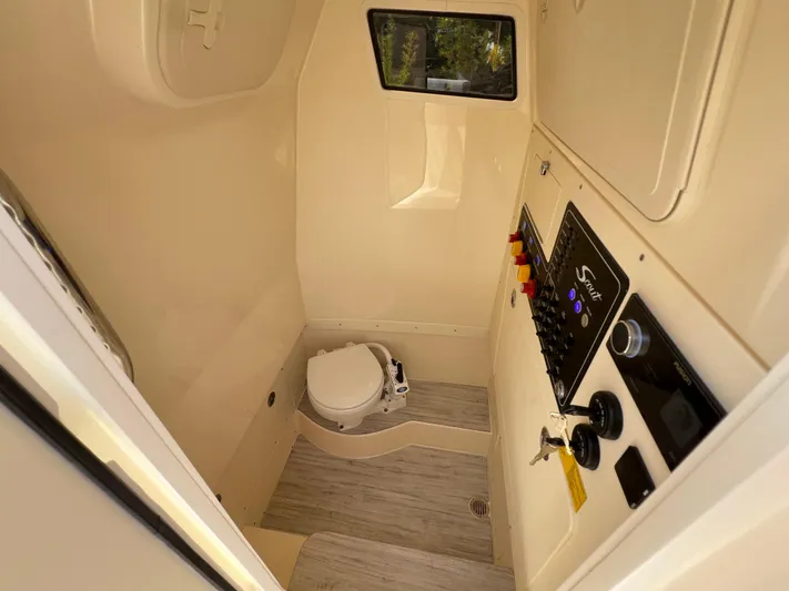 Yacht Photos Pics 2026 Scout 260 LXF boat interior with control panel and marine toilet.