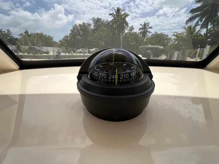  Yacht Photos Pics Compass on 2026 Scout 260 LXF boat, with tropical background and clear sky.