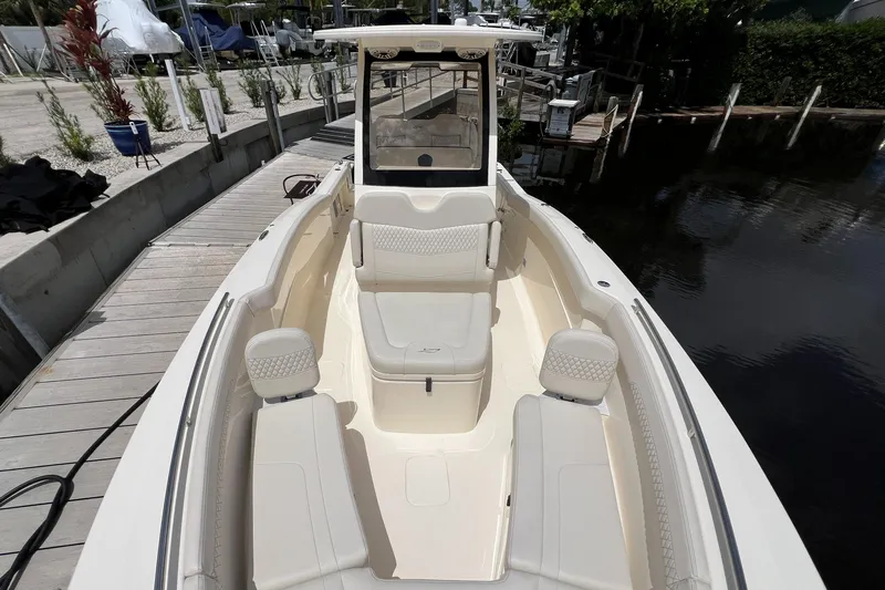  Yacht Photos Pics 2026 Scout 260 LXF boat with luxurious seating at a dock.