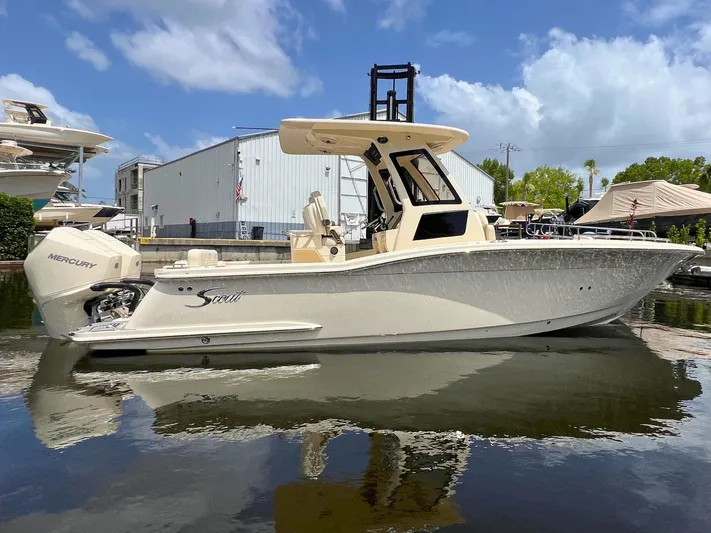  Yacht Photos Pics 2026 Scout 260 LXF boat with Mercury engine docked on a sunny day.