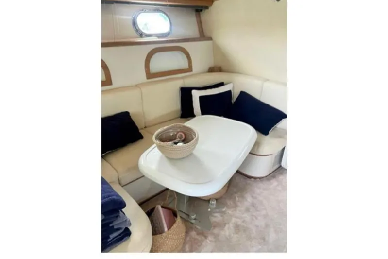  Yacht Photos Pics Interior of 1998 Otam Cigarette Heritage 45 yacht with cozy seating and table.