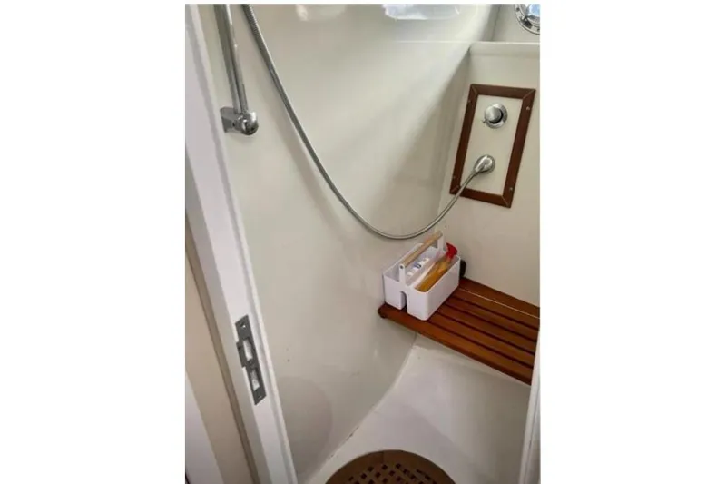  Yacht Photos Pics Shower area in 1998 Otam Cigarette Heritage 45 yacht with wooden seat and toiletries.