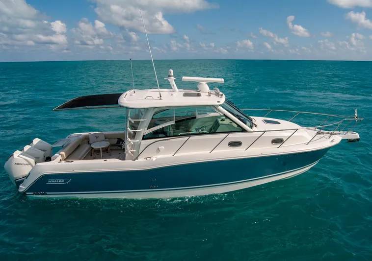  Yacht Photos Pics 2021 Boston Whaler 345 Conquest boat cruising on clear blue ocean waters.