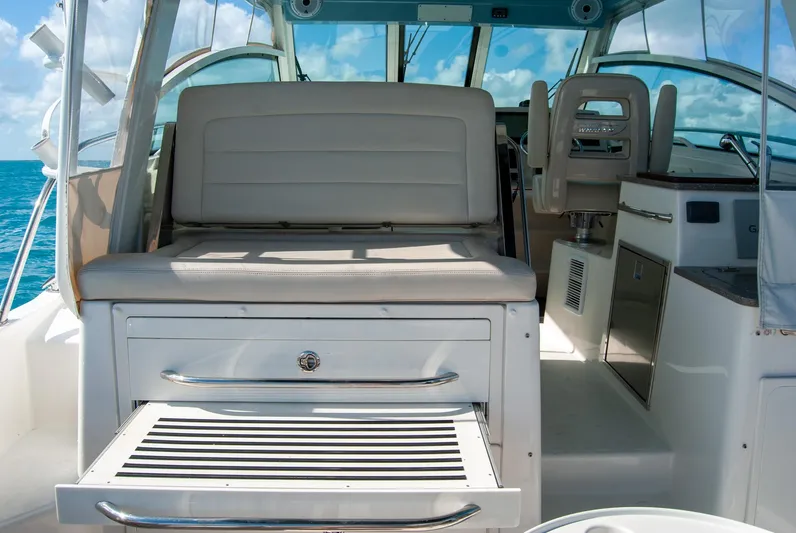  Yacht Photos Pics 2021 Boston Whaler 345 Conquest interior with seating and storage, ocean view in background.