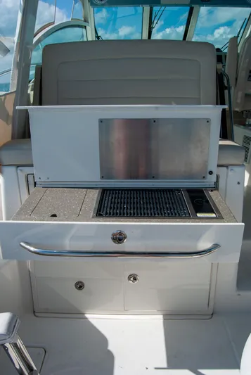  Yacht Photos Pics 2021 Boston Whaler 345 Conquest boat interior with grill and storage compartments.
