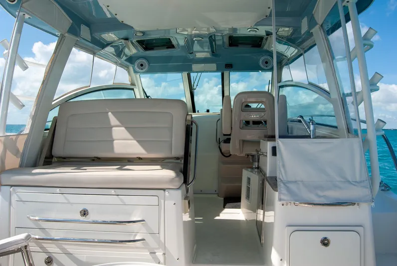  Yacht Photos Pics 2021 Boston Whaler 345 Conquest interior with seating and helm, under clear blue skies.