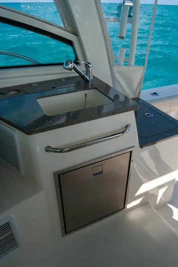  Yacht Photos Pics 2021 Boston Whaler 345 Conquest boat interior with sink and countertop.