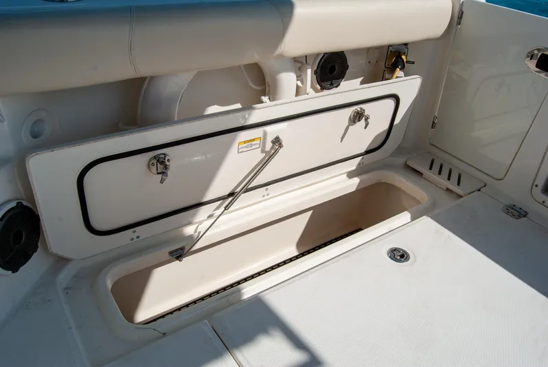  Yacht Photos Pics 2021 Boston Whaler 345 Conquest storage compartment, open and spacious, on a white deck.