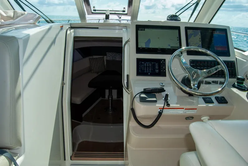  Yacht Photos Pics 2021 Boston Whaler 345 Conquest helm with navigation screens and cabin entrance.