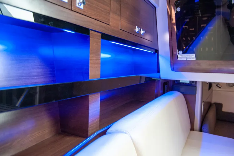  Yacht Photos Pics Interior of 2021 Boston Whaler 345 Conquest with blue LED lighting and wooden cabinetry.