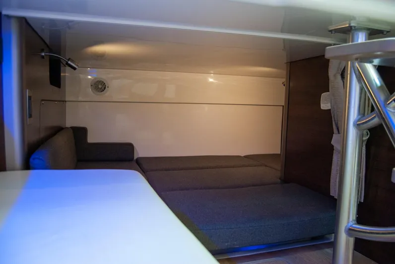  Yacht Photos Pics 2021 Boston Whaler 345 Conquest cabin interior with seating and table.