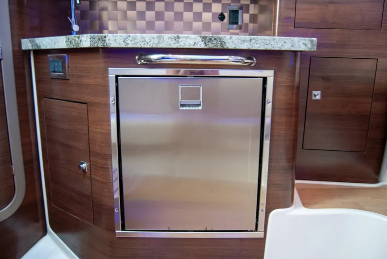  Yacht Photos Pics 2021 Boston Whaler 345 Conquest interior with stainless steel appliance and wood cabinetry.