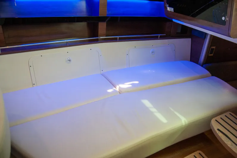  Yacht Photos Pics 2021 Boston Whaler 345 Conquest interior with white seating and ambient blue lighting.