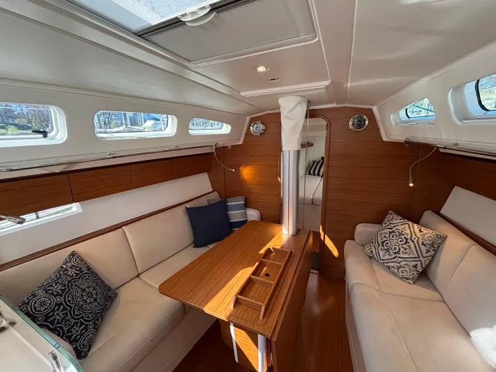 Rambunxious Yacht Photos Pics Luxurious interior of 2014 X-Yachts Xp 38 sailboat with elegant seating and wooden finishes.