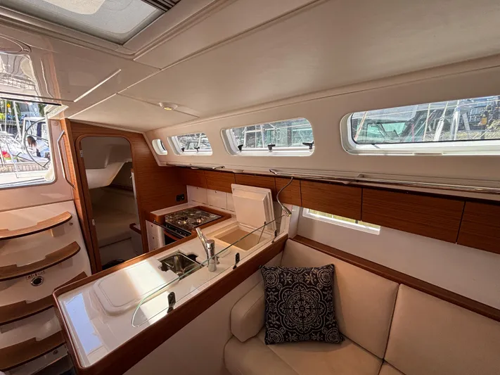 Rambunxious Yacht Photos Pics Interior of 2014 X-Yachts Xp 38 sailboat, featuring a modern kitchen and cozy seating area.