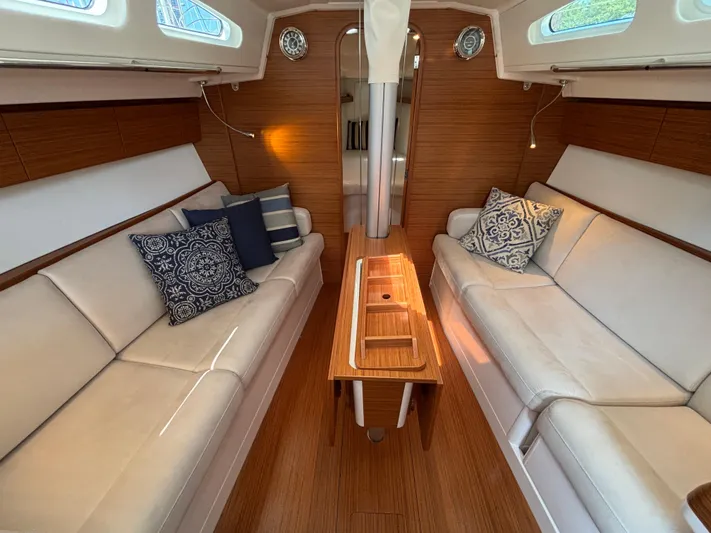 Rambunxious Yacht Photos Pics Luxurious interior of 2014 X-Yachts Xp 38 with elegant wood finish and plush seating.