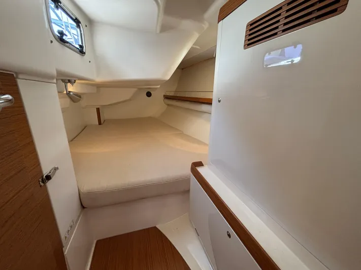 Rambunxious Yacht Photos Pics 2014 X-Yachts Xp 38 cabin interior with cozy bed and wooden accents.