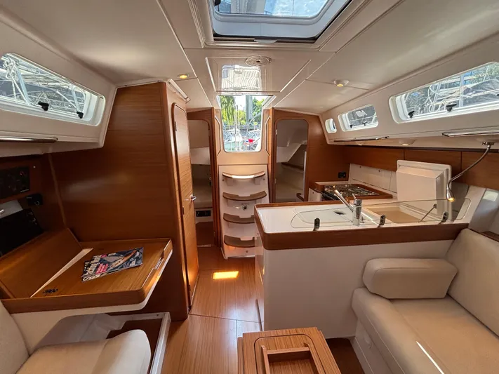 Rambunxious Yacht Photos Pics Interior of 2014 X-Yachts Xp 38 sailboat, featuring modern wood finish and spacious layout.