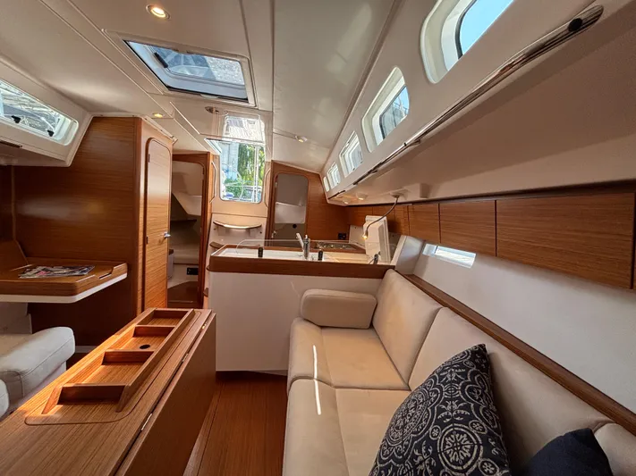 Rambunxious Yacht Photos Pics Luxurious interior of 2014 X-Yachts Xp 38 sailboat with modern wood finish and seating.
