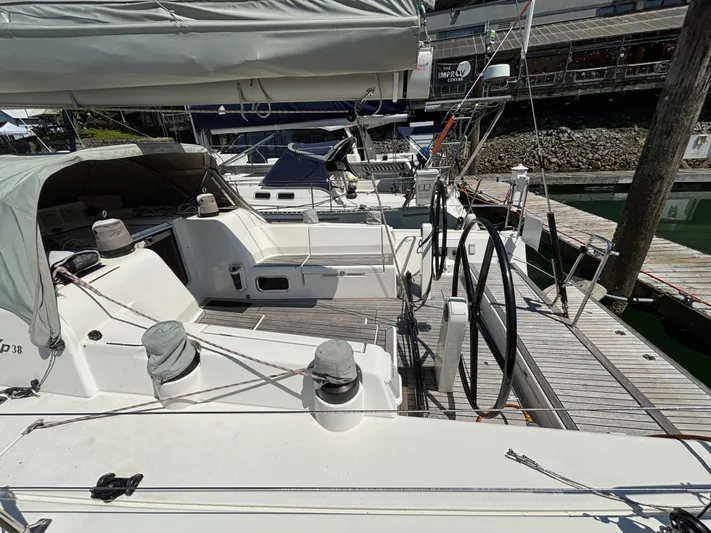 Rambunxious Yacht Photos Pics 2014 X-Yachts Xp 38 sailboat docked, featuring a spacious cockpit and dual steering wheels.