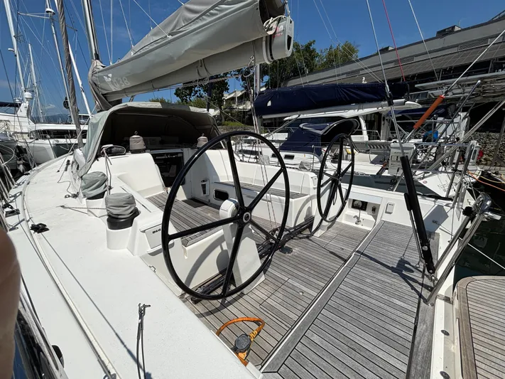 Rambunxious Yacht Photos Pics 2014 X-Yachts Xp 38 sailboat with dual steering wheels, docked in a marina.