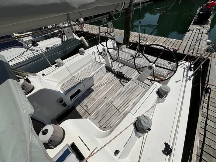 Rambunxious Yacht Photos Pics 2014 X-Yachts Xp 38 sailboat cockpit with dual steering wheels, docked at marina.