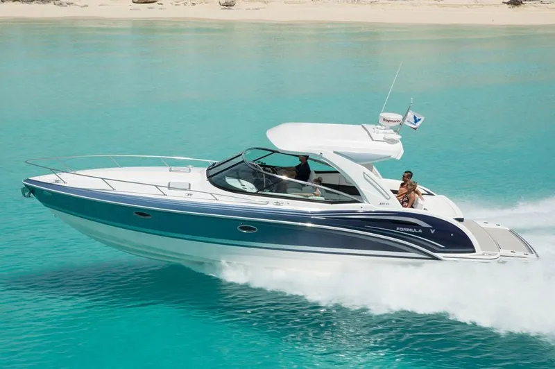  Yacht Photos Pics Manufacturer Provided Image: 2020 Formula 350 Sun Sport cruising on turquoise water near a sandy beach.