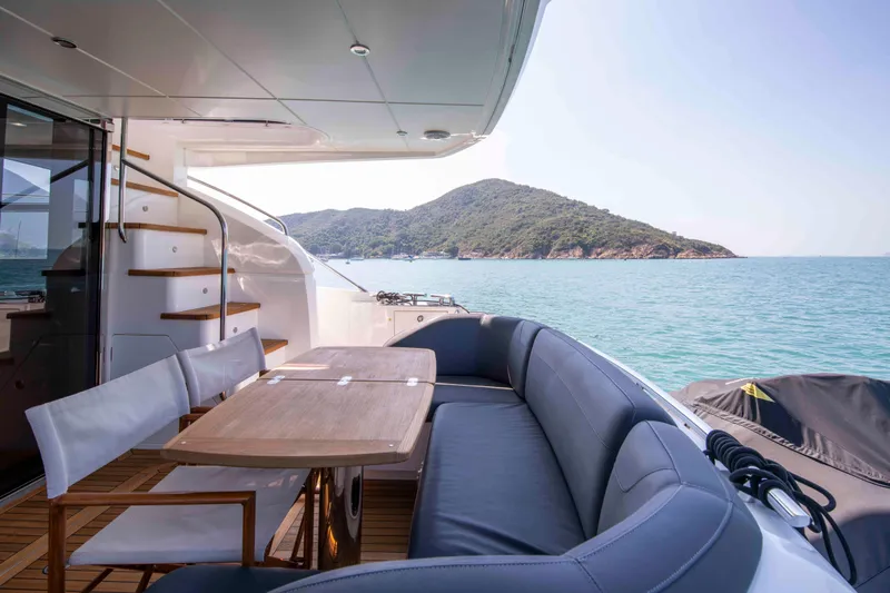  Yacht Photos Pics Luxurious 2017 Princess 52 yacht deck with seating, table, and scenic ocean view.